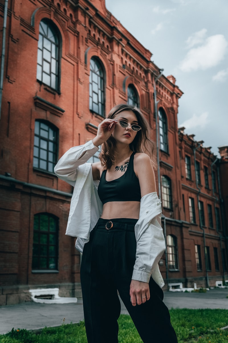 Street style model layering a cropped jacket and cardigan