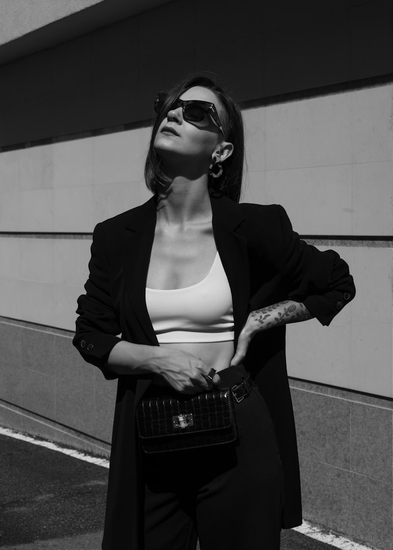 Model in black and white tailoring against concrete
