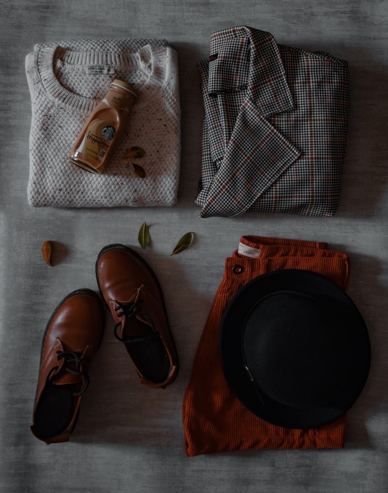 Heritage knit sweater folded with brogues and a wool hat