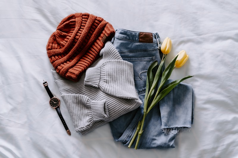 Ribbed beanie folded on denim with a watch