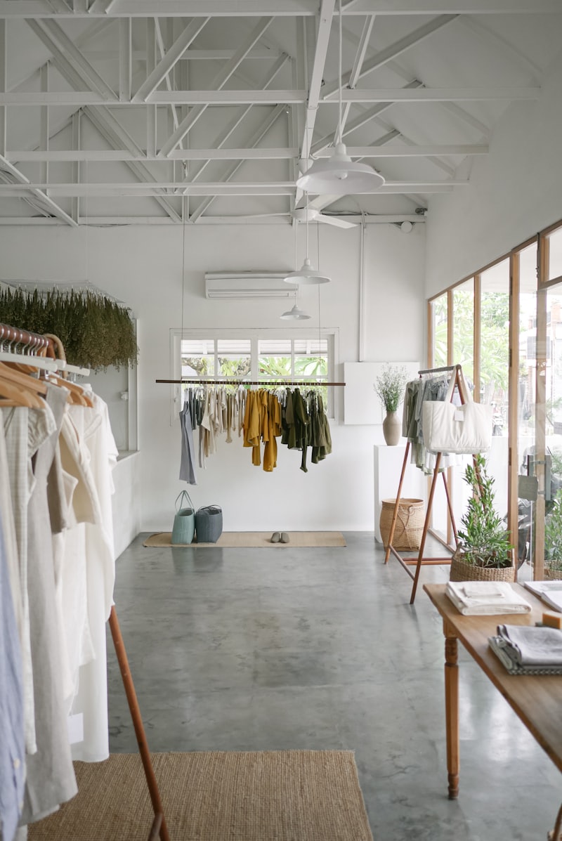 Bright minimalist boutique interior with neutral garments