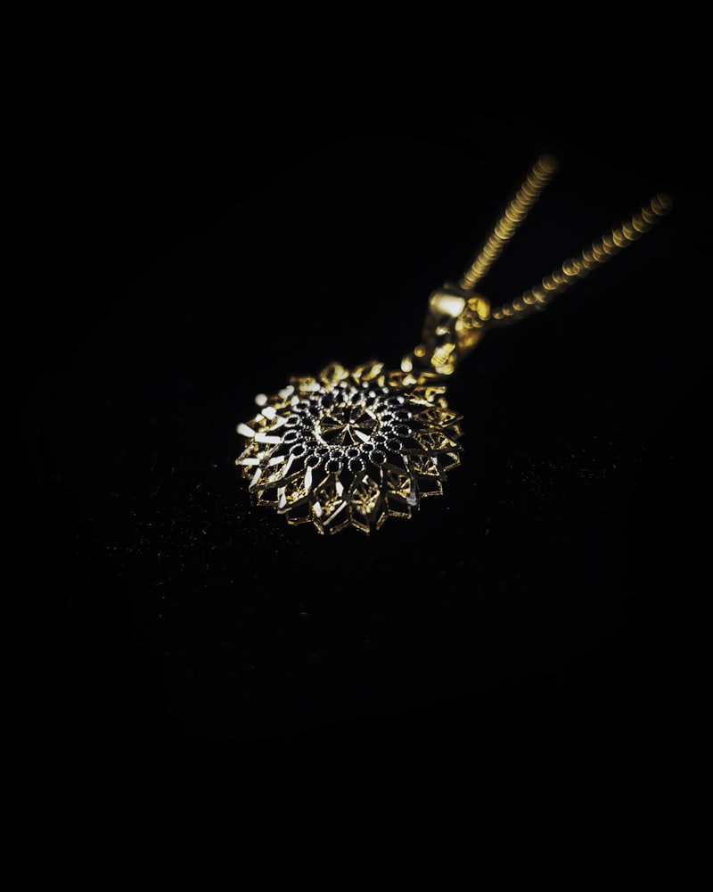 A radiant gold sunburst pendant on a fine chain