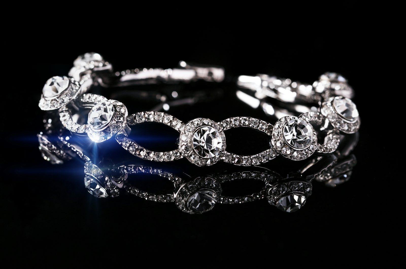 A diamond bracelet resting on black velvet, catching light