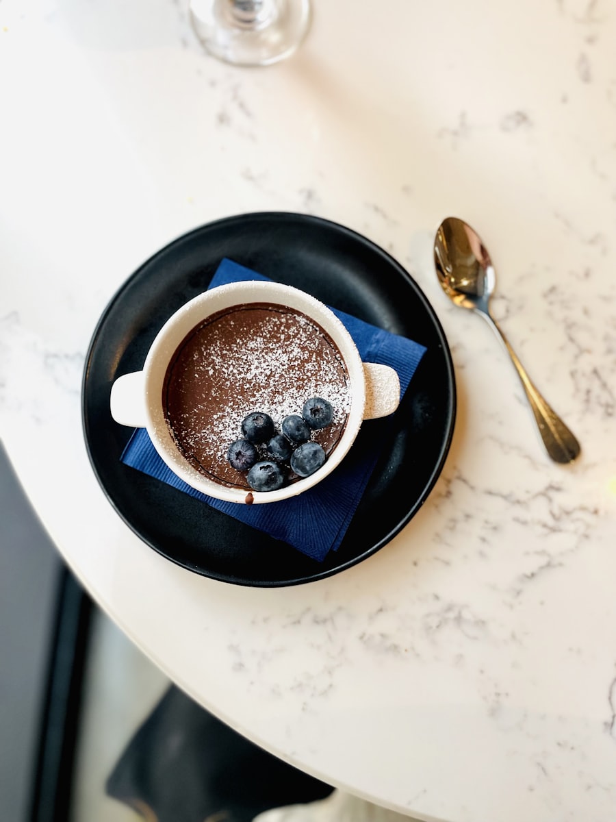 Chocolate cremeux dessert with blackberries in a dark bowl