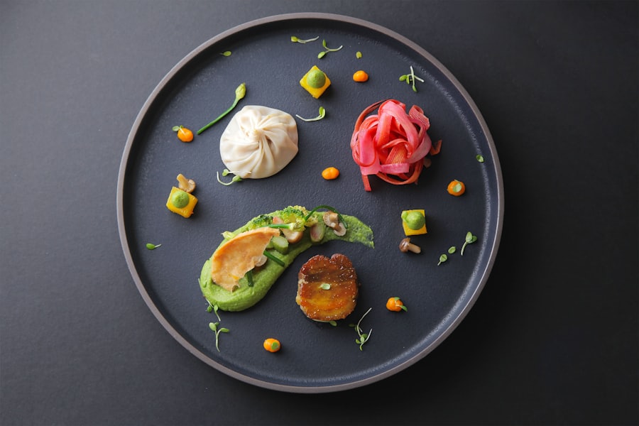 Hokkaido scallop with cauliflower and caviar on a black plate