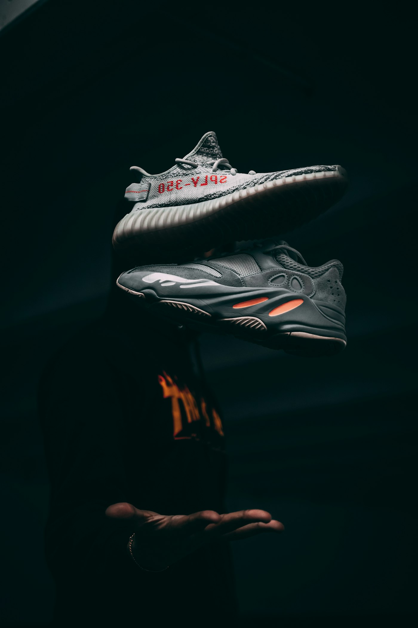 VOLTA AERO Ion sneaker floating on a dark studio pedestal with cyan glow